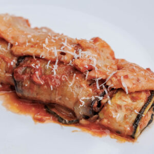 Aubergine and Courgette rolls -Delicious vegetable rolls with buffalo mozzarella, served with tomato, parmesan and basil garnish