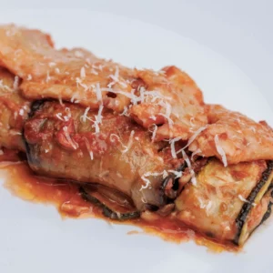 Aubergine and Courgette rolls -Delicious vegetable rolls with buffalo mozzarella, served with tomato, parmesan and basil garnish